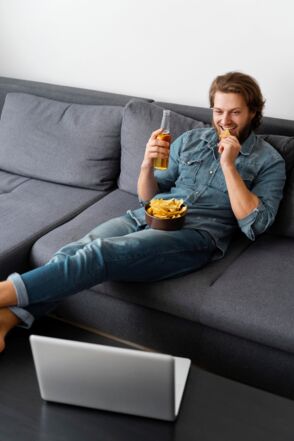 Image by <a href="https://www.freepik.com/free-photo/full-shot-man-sitting-couch-with-drink_13375529.htm#query=full-shot-man-sitting-couch-with-drink-freepik&position=1&from_view=search&track=sph">Freepik</a>