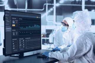 Factory workers utilizing Impact Manager software. Factory workers utilizing Impact Manager software.