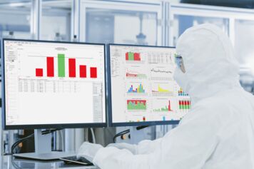 Engineer in the fab looking at FabTime charts Engineer in the fab looking at FabTime charts