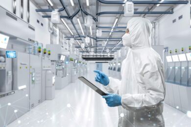 Technician in a semi fab looking at equipment Technician in a semi fab looking at equipment